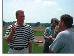 Photo of researcher answering turf-related questions
