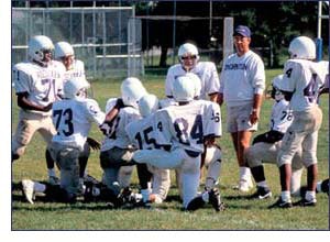 Photo of football coach with team