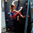 Photo of girl climbing on rotating wall