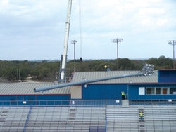 Photo of a defective light pole that fell in the direction of a vacant gym at Hays High School