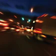Blurred photo of cars driving along a highway at night illustrating the effect of driving under the influence