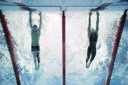 Photo of Michael Phelps (left) securing his seventh gold medal in Beijing by being the first to stop his lane's timing mechanism