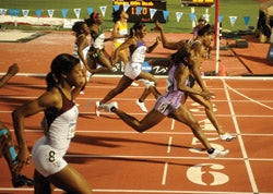 Photo of women runners crossing the finish line of an elite-level track meet
