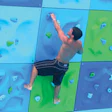 Photo of a student climbing the bouldering wall at the Southeast Missouri State University Aquatic Center