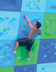 Photo of a student climbing the bouldering wall at the Southeast Missouri State University Aquatic Center