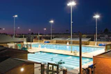 HEAT OF THE NIGHTSolar panels on top of the shade structure keep the pool at Coronado (Calif.) High School's Brian Bent Memorial Aquatics Complex warm enough for after-dark competitions.