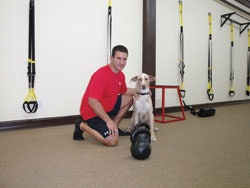 Photo of Supreme Ultimate Fitness owner Dale Buchanan with his dog Spaulding