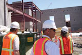 Photo of a building code official surveying a facility under construction