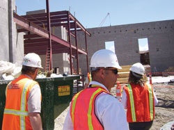Photo of a building code official surveying a facility under construction