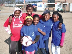 Photo of South African children holding a soccer ball