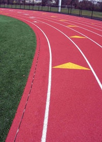 MIND THE GAP Providing a clean look to the track surface, a slot drain system must be regularly flushed of debris.