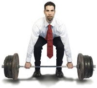 Photo of a man in business attire lifting weights