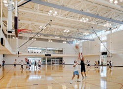 ABOVE BOARDS Basketball goals that drop into position from the ceiling dominate today's gymnasium market.