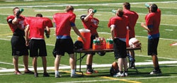SUPERVISED DRINKING McMinnville (Ore.) High School football players are shown hydrating just days after 19 of the team's players were diagnosed with rhabdomyolysis during a summertime training session that was unregulated by the state athletic association.