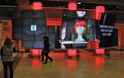 Photo of people walking by LCD screens in Toronto's Air Canada Centre