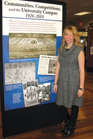 Photo of Sara Beth Gideon with her exhibit, Communities, Competitions and the University Campus, 1926-2010