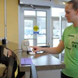 Photo of a member signing in using thumbprint scan technology