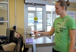 Photo of a member signing in using thumbprint scan technology