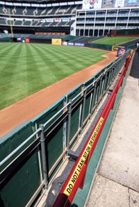 Until railing heights are adjusted at Rangers Ballpark, warning signs discourage fans from engaging in high-risk behaviors. (AP Photo/The Fort Worth Star-Telegram, Ron Jenkins)