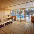 Ample glass and a high-visibility location on the pool deck help discourage inappropriate uses of saunas and steam rooms. (Photo by Sam Fentress/Fentress Photography, courtesy of Hastings + Chivetta Architects Inc.)