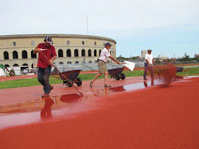 A wear layer of rubber granules is applied to the track at Harvard University.