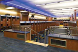 SEATING BOWL Michigan's sunken football locker room places players on separate but visually connected tiers. (Photo by Paul Bednarski)