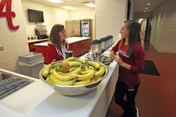 SMOOTHIE OPERATOR As the University of Alabama's director of performance nutrition, Amy Bragg (left) strategizes with student-athletes about food selection. (Photo courtesy of the University of Alabama)