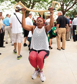 SWING SETS A woman tests out the equipment at the grand opening of the TPL Fitness Zone in West Perrine Park, Miami, Fla. (Photo courtesy of Tom Clark/TPL )