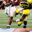 HARD KNOCKS As Alabama was pounding Michigan's Denard Robinson, Michigan State players were piling on via Twitter. (AP Photo/LM Otero)