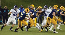 BATTLEGROUND STATE Cleveland's Saint Ignatius (in blue), an all-boys school, won its record 11th Ohio state football championship in 2011 with a 34-13 win over Pickerington Central - fueling calls for separate tournaments for public and non-public schools (Photo by Impact Action Sports Photography, courtesy of OHSAA)