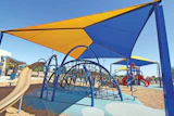 SUNSCREENS Carefully placed shade structures protect children during the hottest part of the day. (Photo Courtesy of Shade 'N Net)