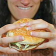 DROP THAT BURGER! The first steps toward helping people live healthier lives is telling them to eat less and walk more. (image DrRave/istockphoto.com)