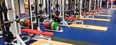 A NEEDED LIFT The days of simply installing 3⁄8-inch speckled rubber flooring in weight rooms are over as aesthetics, branding, performance and cleanability are prioritized in colleges and rec centers. (Univ South Methodist Weight Room)