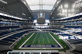 A man was injured when he fell from the first row of AT&T Stadium down to the field-level suites below.