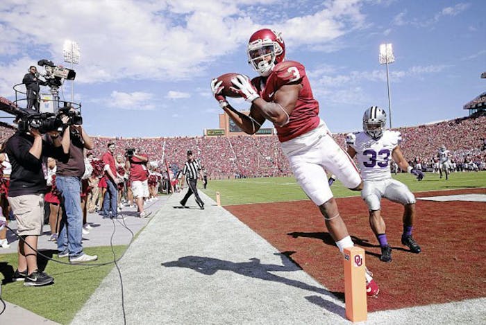 This photo of Oklahoma wide receiver Sterlling Shepard was captured by Mike Simons of the Tulsa Word, just before Shepard collided with Simons and landed on his camera gear.