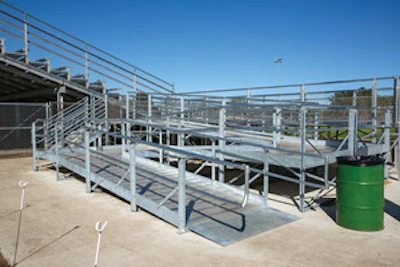 END AROUND Located along the right side of an existing grandstand, this 48-foot-long switch-back ramp allows wheelchair users to elevate themselves four feet off the ground. - Click to enlarge