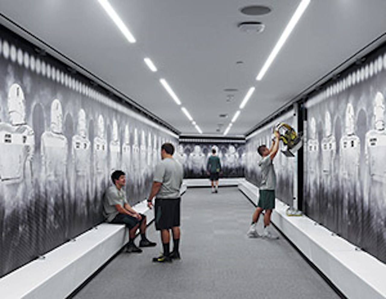 The clean look of the Oregon football locker room features integrated bench seating and pocket doors that disappear into the locker itself. (Photo by Eric Evans/University of Oregon Athletics) - Click to enlarge