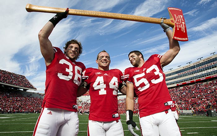 Chris Borland, middle, celebrates a Wisconsin Badgers victory over Minnesota. Borland, 24, is retiring from the NFL after just one season citing concerns over his health. (Photo by Brian Ebner)