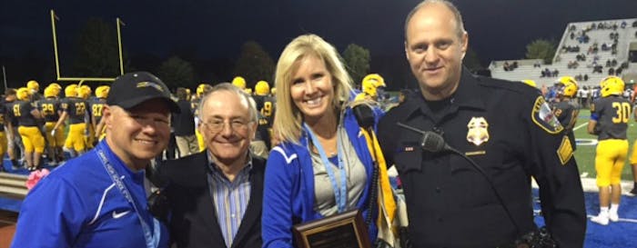 Carmel (Ind.) High School was recognized with the Sports Event Security Aware designation during a football game this past fall. From left to right are Carmel athletics director Jim Inskeep, NCS4 Director Lou Marciani, Carmel assistant principal Amy Skeens-Benton and Carmel Police Sgt. Phil Hobson. (Photo courtesy of Carmel High School.)