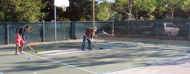 Volunteers paint the pickleball courts at ACC Senior Services in Sacramento, Calif. [Photo by Heman Lee]