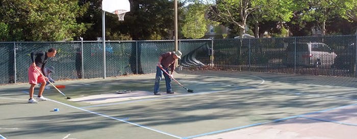 Volunteers paint the pickleball courts at ACC Senior Services in Sacramento, Calif. [Photo by Heman Lee]