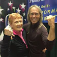 Elaine LaLanne and her son, Jon, do the famous Jack LaLanne muscle pose in their booth at the IDEA World convention last July in Los Angeles. (Photo by Stuart Goldman.)