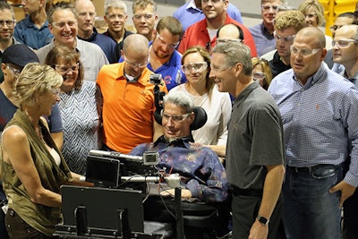 Augie Nieto (center) and wife Lynne during a 2016 visit to a Life Fitness Factory. (Photo courtesy of Life Fitness.)