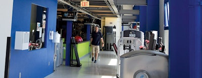 Exposed steel beams pay homage to the history of a repurposed steel warehouse that now houses a health club. [Photo courtesy of Steel Fitness Riverport]