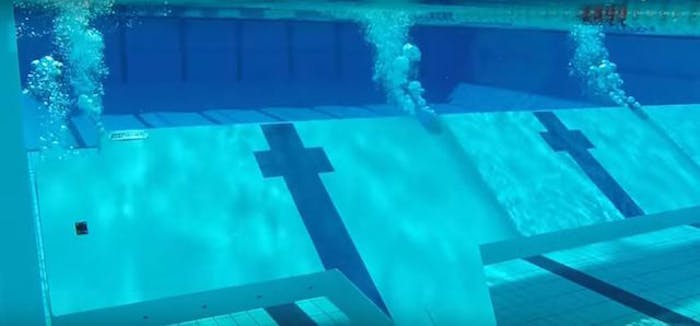 SwimWall Systems lift from the pool floor and lowers using displacement of water and air, with all operation taking place from the pool deck.