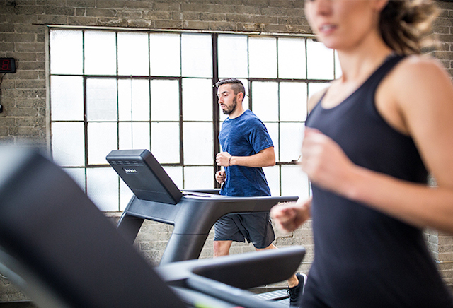 [Runners on SportsArt treadmills]