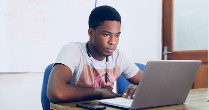 [Image of young man on laptop]