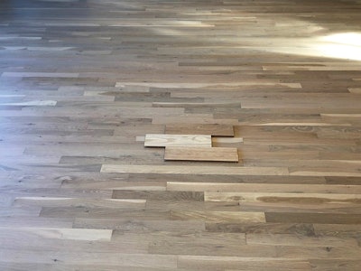 Raw white oak planks on top of a finished floor. (Photos courtesy of Marcin Zyskowski)