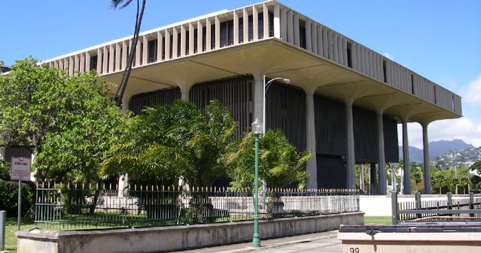 View of the Hawaii State Capitol with the Koʻolau mountains visible in the background.