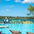 Outdoor amenities at the Saint Leo U. Wellness Center include an infinity-edged recreational pool, resort style seating, a fire pit, and a barbecue area — all with a beautiful view of Lake Jovita.